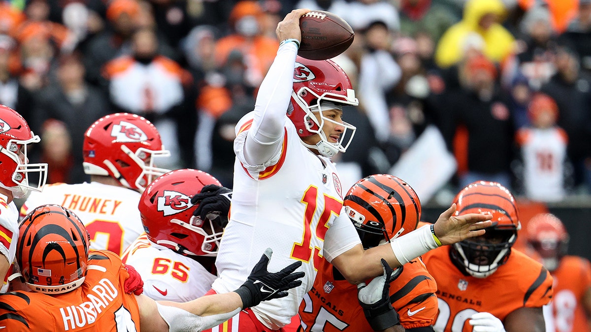Patrick Mahomes (15) of the Kansas City Chiefs is pressured by the defense of the Cincinnati Bengals during the first quarter of the game at Paul Brown Stadium on Jan. 2, 2022, in Cincinnati, Ohio.
