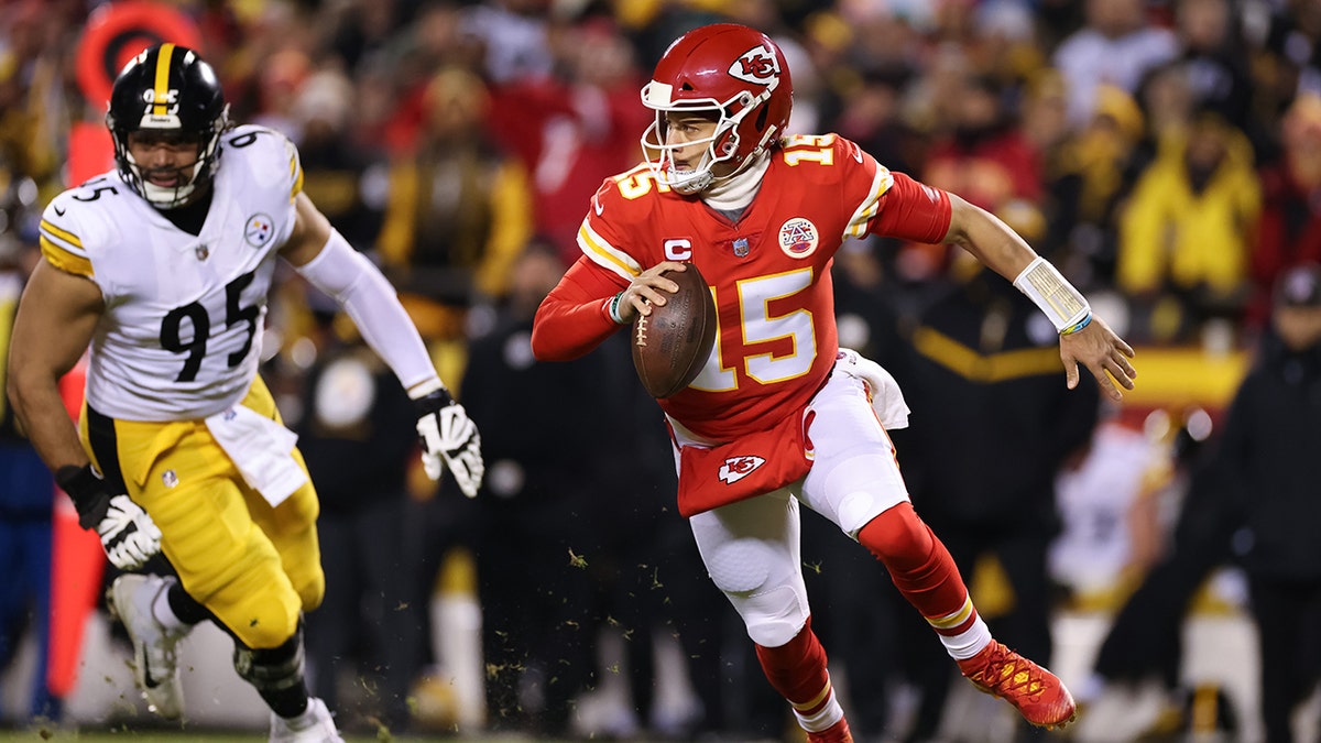 Patrick Mahomes (15) of the Kansas City Chiefs scrambles out of the pocket with the ball in the first quarter of the game against the Pittsburgh Steelers in the NFC wild-card playoff game at Arrowhead Stadium on Jan. 16, 2022, in Kansas City, Missouri.