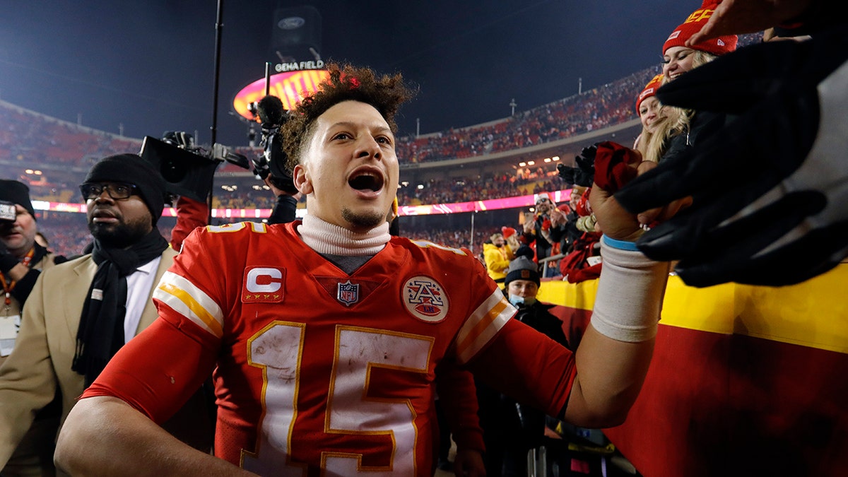 Kansas City Chiefs quarterback Patrick Mahomes celebrates with fans as he walks off the field after an NFL divisional-round playoff football game against the Buffalo Bills, Sunday, Jan. 23, 2022, in Kansas City, Missouri.