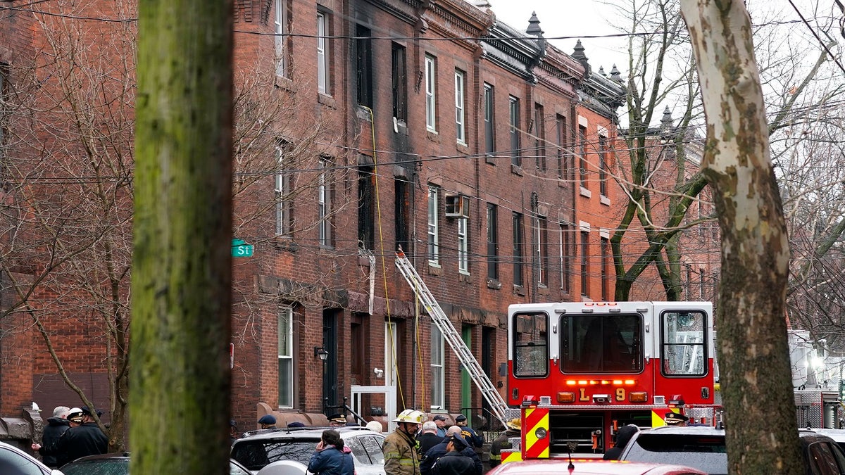 Firefighters work at the scene of a deadly rowhouse fire Wednesday in the Fairmount neighborhood of Philadelphia.