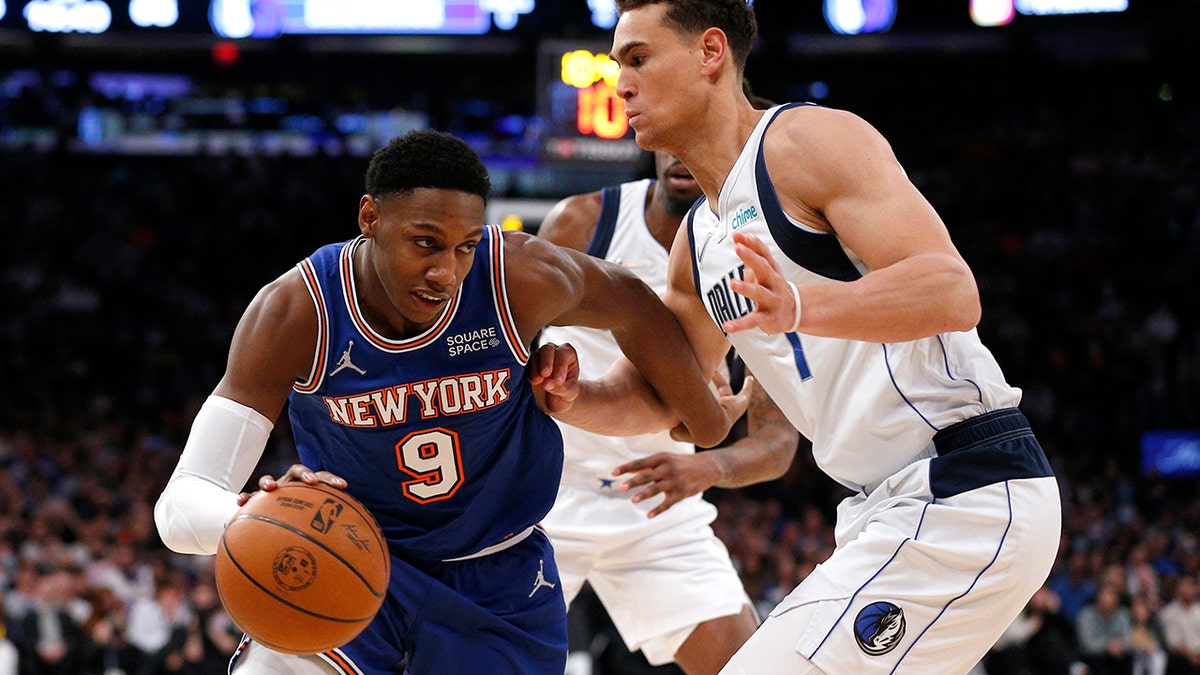 New York Knicks guard RJ Barrett (9) drives to the basket against Dallas Mavericks center Dwight Powell (7) during the second half of an NBA basketball game, Wednesday, Jan. 12, 2022, in New York.