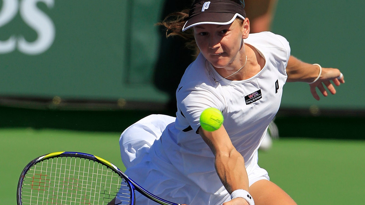 Renata Voracova of the Czech Republic returns a shot to Shuai Peng of China during a first round match at the BNP Paribas Open tennis tournament in Indian Wells, California, on March 10, 2011.