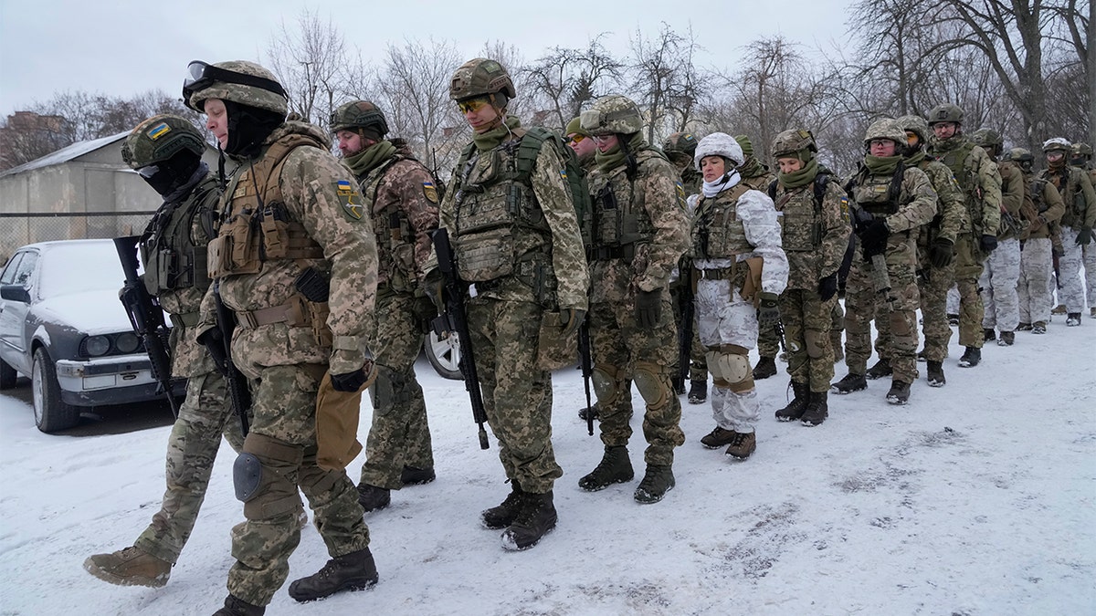 Members of Ukraine's Territorial Defense Forces, volunteer military units of the Armed Forces, train in a city park in Kyiv, Ukraine, Saturday, Jan. 22, 2022. Dozens of civilians have been joining Ukraine's army reserves in recent weeks amid fears about Russian invasion. (AP Photo/Efrem Lukatsky)