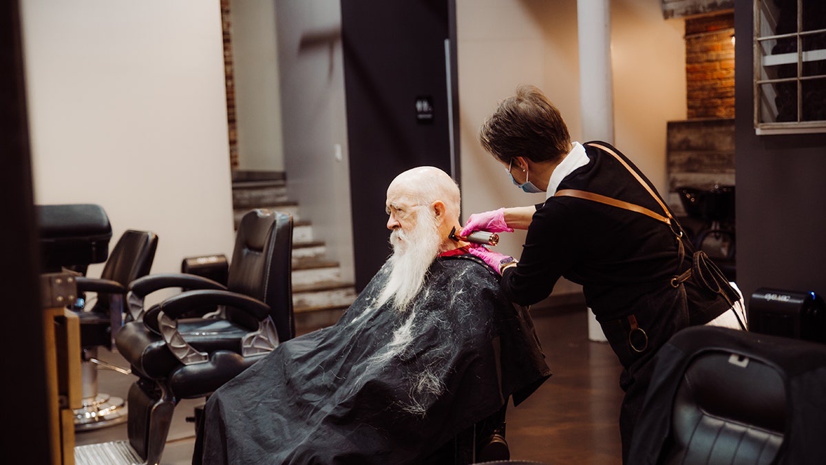 Santa Walt getting his beard shaved