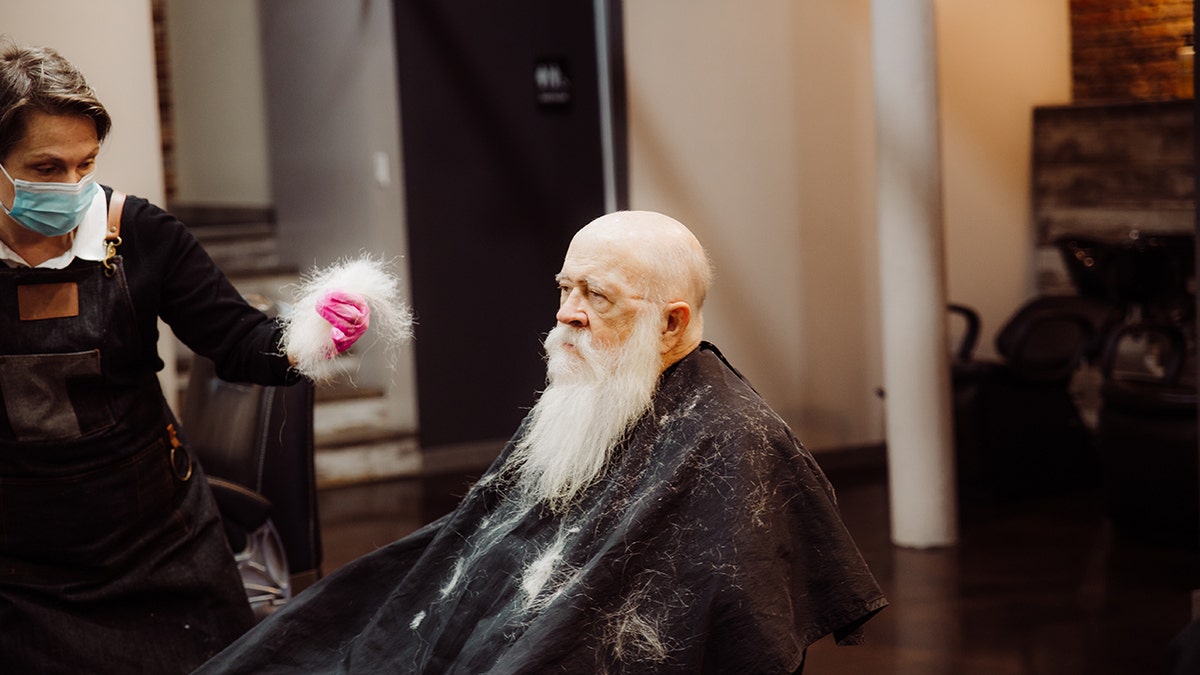 Santa Walt getting his beard shaved