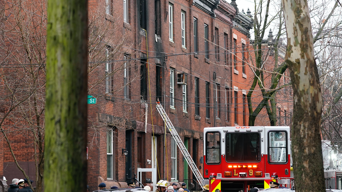 Philadelphia firefighters work at the scene of a deadly row house fire, Wednesday, Jan. 5, 2022, in the Fairmount neighborhood of Philadelphia. (AP Photo/Matt Rourke)