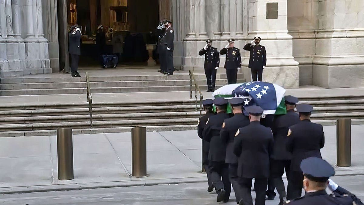 A casket carrying the body of NYPD Officer Jason Rivera body arrives at Saint Patrick .