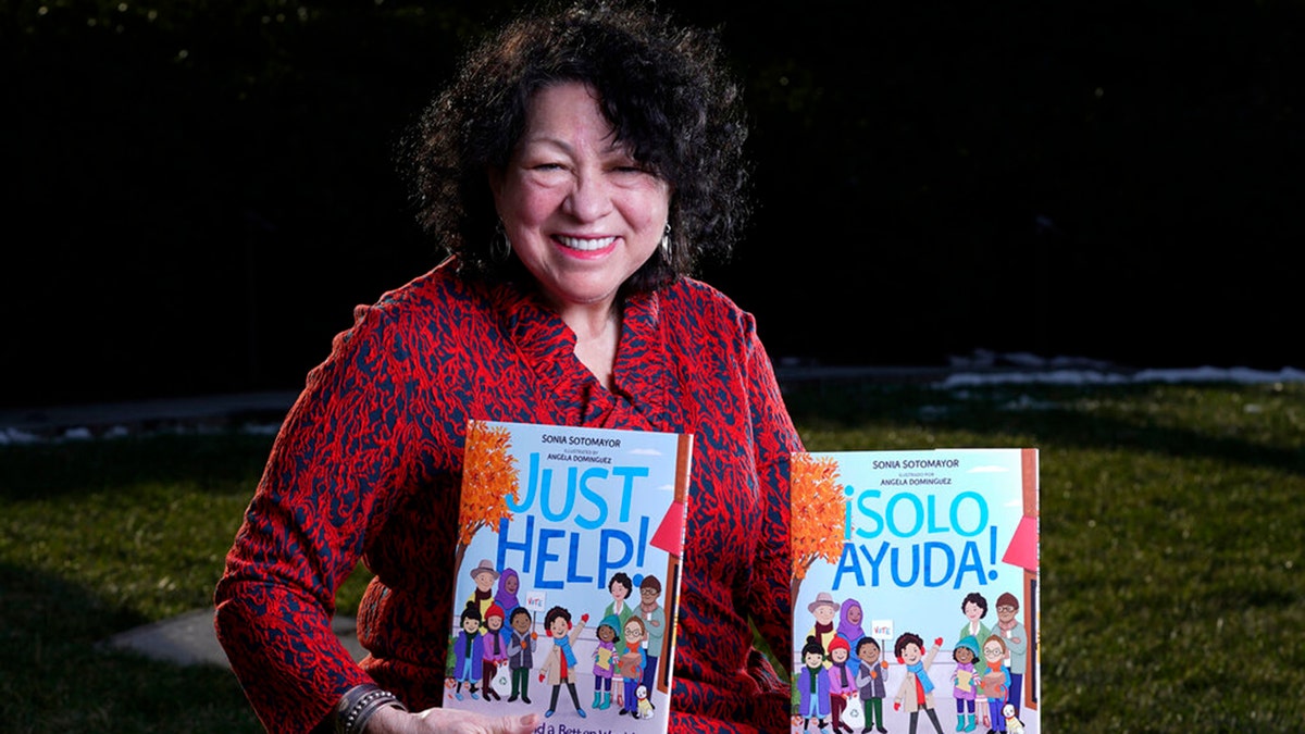 Supreme Court Associate Justice Sonia Sotomayor holds her new children's book "Just Help!" on Capitol Hill in Washington, Wednesday, Jan. 19, 2022. The book has been published in both English and Spanish.