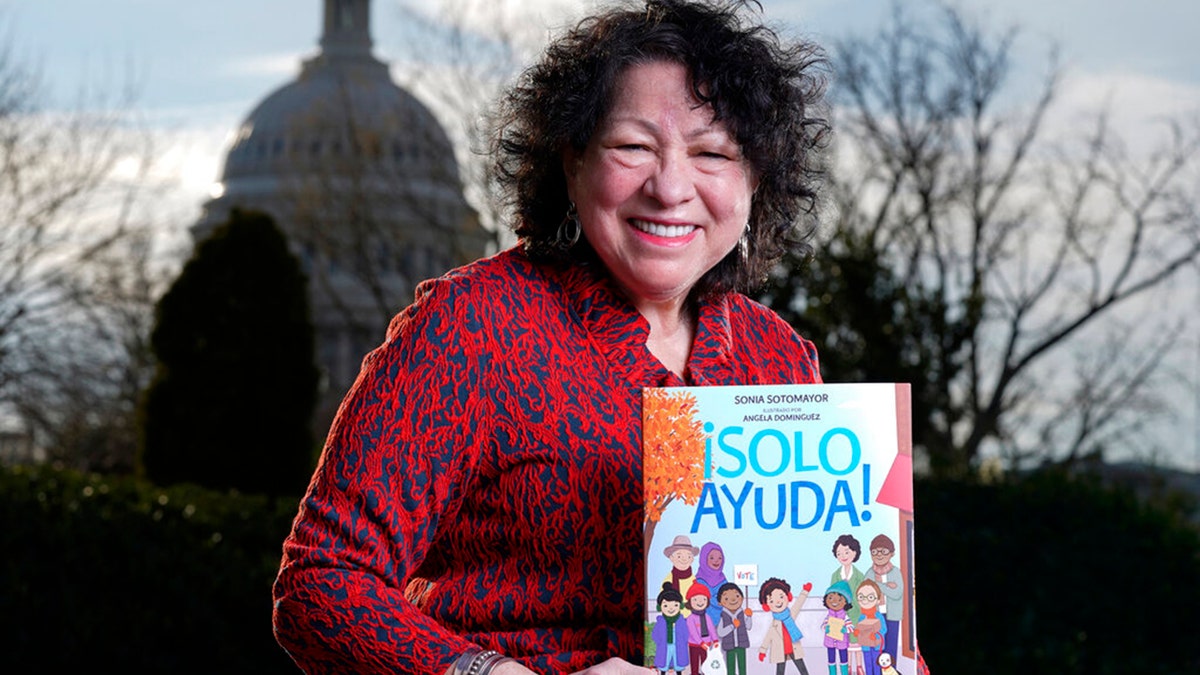 Supreme Court Associate Justice Sonia Sotomayor holds her new children's book "Just Help!" on Capitol Hill in Washington, Wednesday, Jan. 19, 2022.