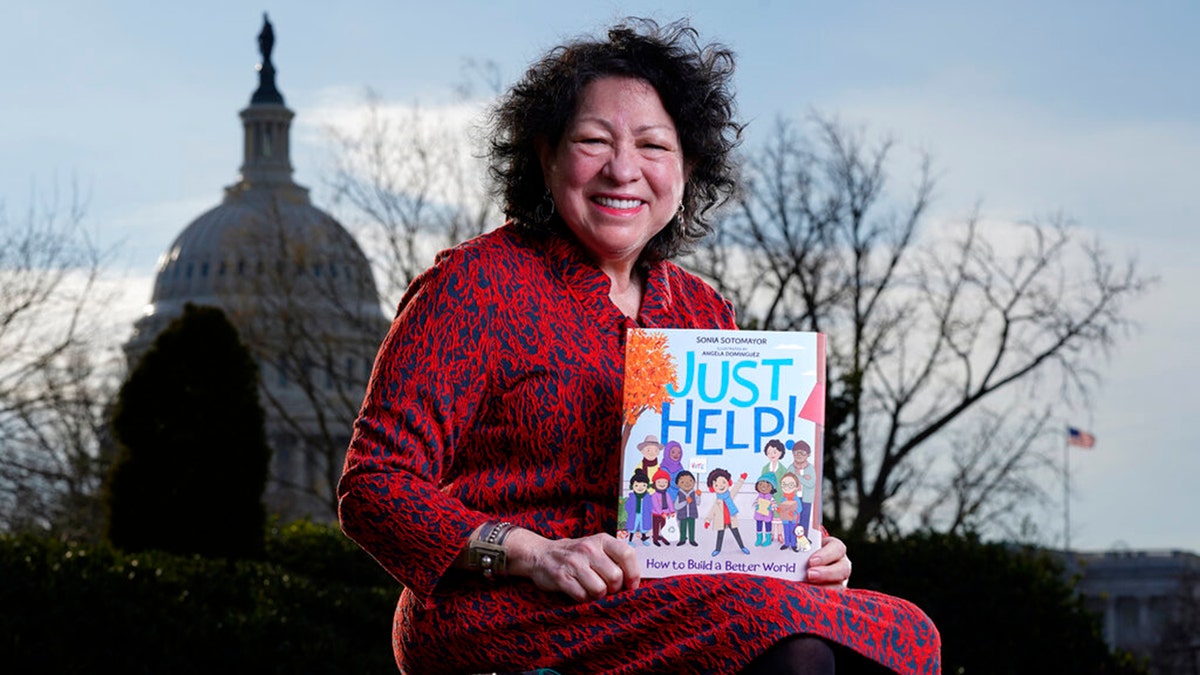 Supreme Court Associate Justice Sonia Sotomayor holds her new children's book "Just Help!" on Capitol Hill in Washington, Wednesday, Jan. 19, 2022.