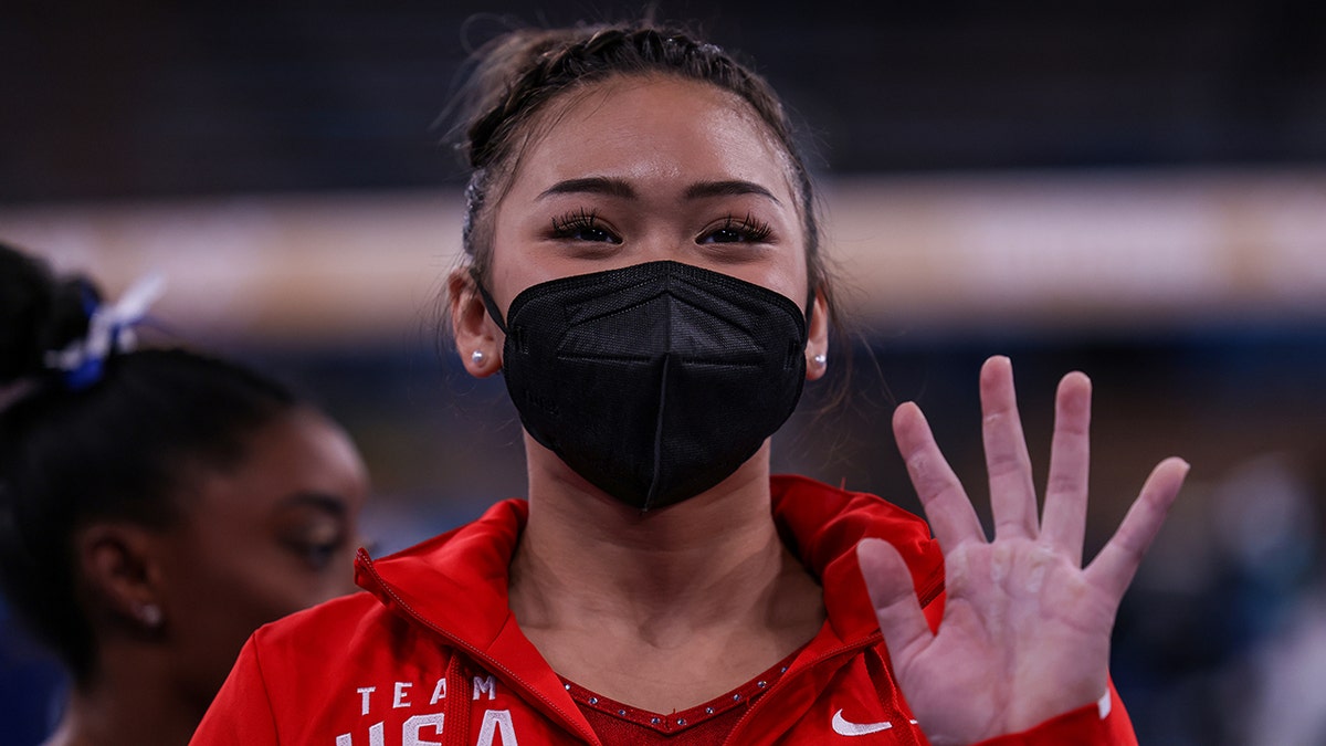 USA gymnast Sunisa Lee waves to fans after competing in the Tokyo 2020 Olympics Womens Balance Beam Final at Ariake Gymnastics Centre.