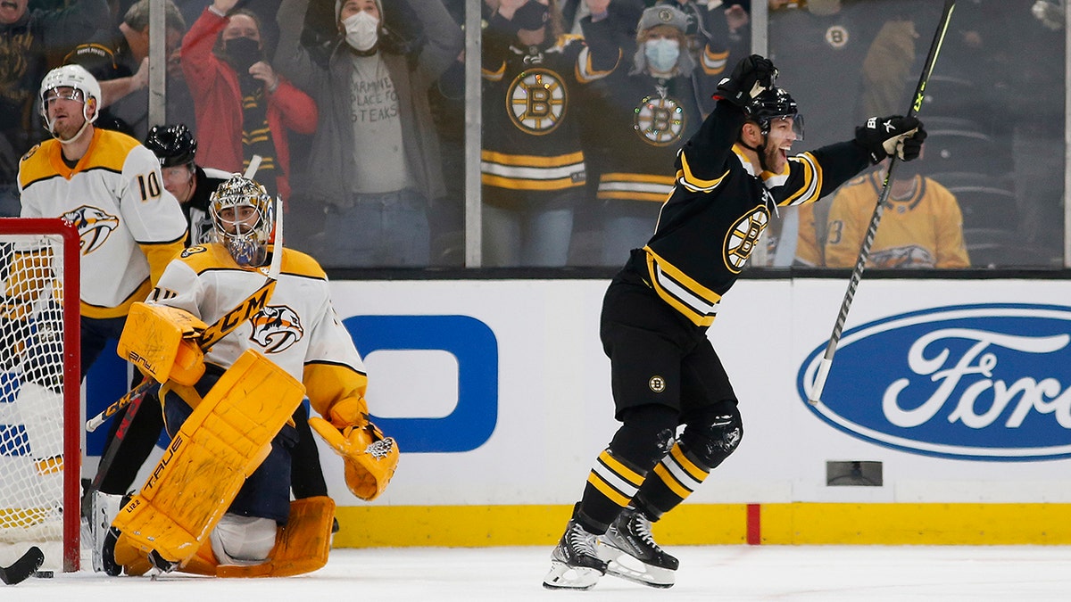 Boston Bruins' Taylor Hall celebrates his game winning goal in overtime on Nashville Predators goaltender Juuse Saros during an NHL hockey game Saturday, Jan. 15, 2022, in Boston. Hall scored off a rebound of David Pastrnak’s shot 1:41 into overtime, lifting the red-hot Boston Bruins to a 4-3 win over Nashville.