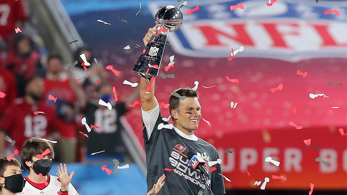 Super Bowl MVP Tom Brady of the Buccaneers holds the Lombardi Trophy as he is surrounded by his kids Benjamin Brady, John Edward Thomas Moynahan and Vivian Lake Brady after the Super Bowl LV game between the Kansas City Chiefs and the Tampa Bay Buccaneers on Feb. 7, 2021, at Raymond James Stadium, in Tampa, Florida.