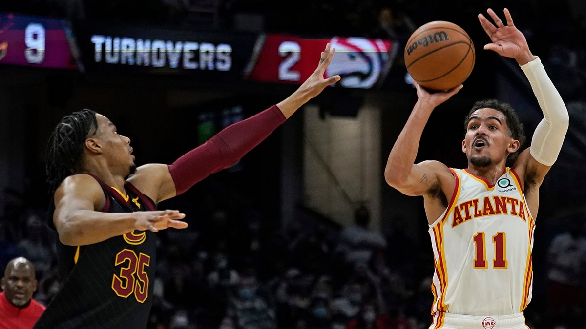 Atlanta Hawks' Trae Young (11) shoots against Cleveland Cavaliers' Isaac Okoro (35) during the second half of an NBA basketball game Friday, Dec. 31, 2021, in Cleveland.