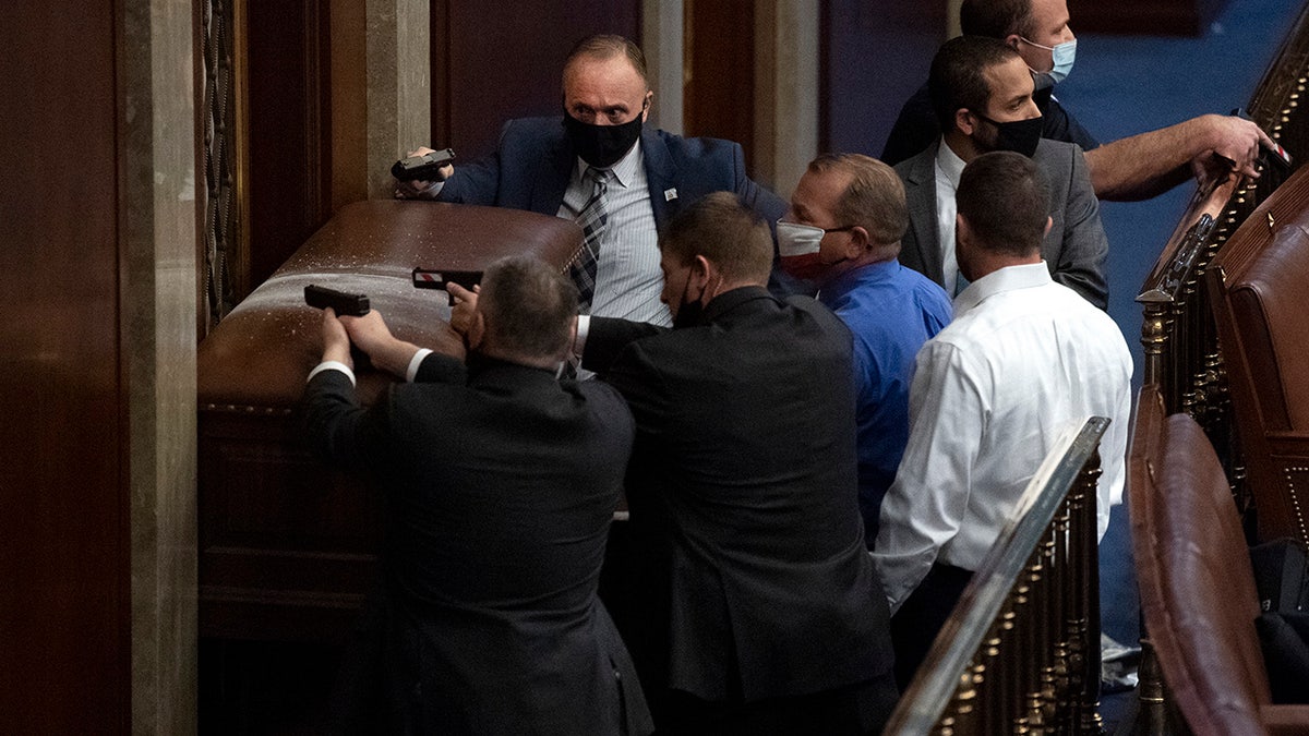 Security barricades the door of the House chamber as rioters disrupt the joint session of Congress to certify the Electoral College vote Jan. 6, 2021