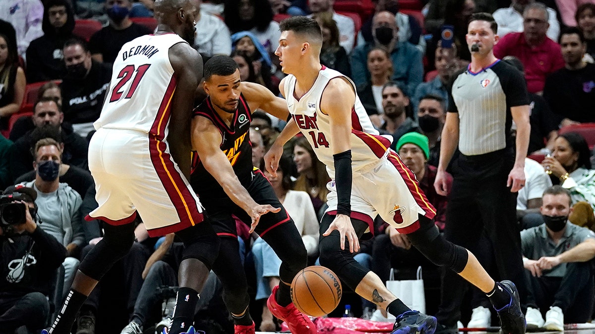Miami Heat guard Tyler Herro (14) drives to the basket as Atlanta Hawks guard Timothe Luwawu-Cabarrot, left, defends during the first half of an NBA basketball game, Friday, Jan. 14, 2022, in Miami.