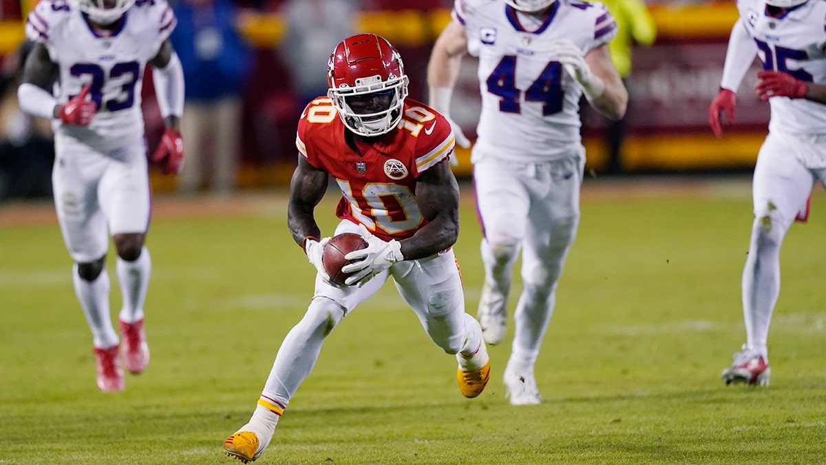 Kansas City Chiefs wide receiver Tyreek Hill (10) returns a punt during the second half of an NFL divisional round playoff football game against the Buffalo Bills, Sunday, Jan. 23, 2022, in Kansas City, Mo. 