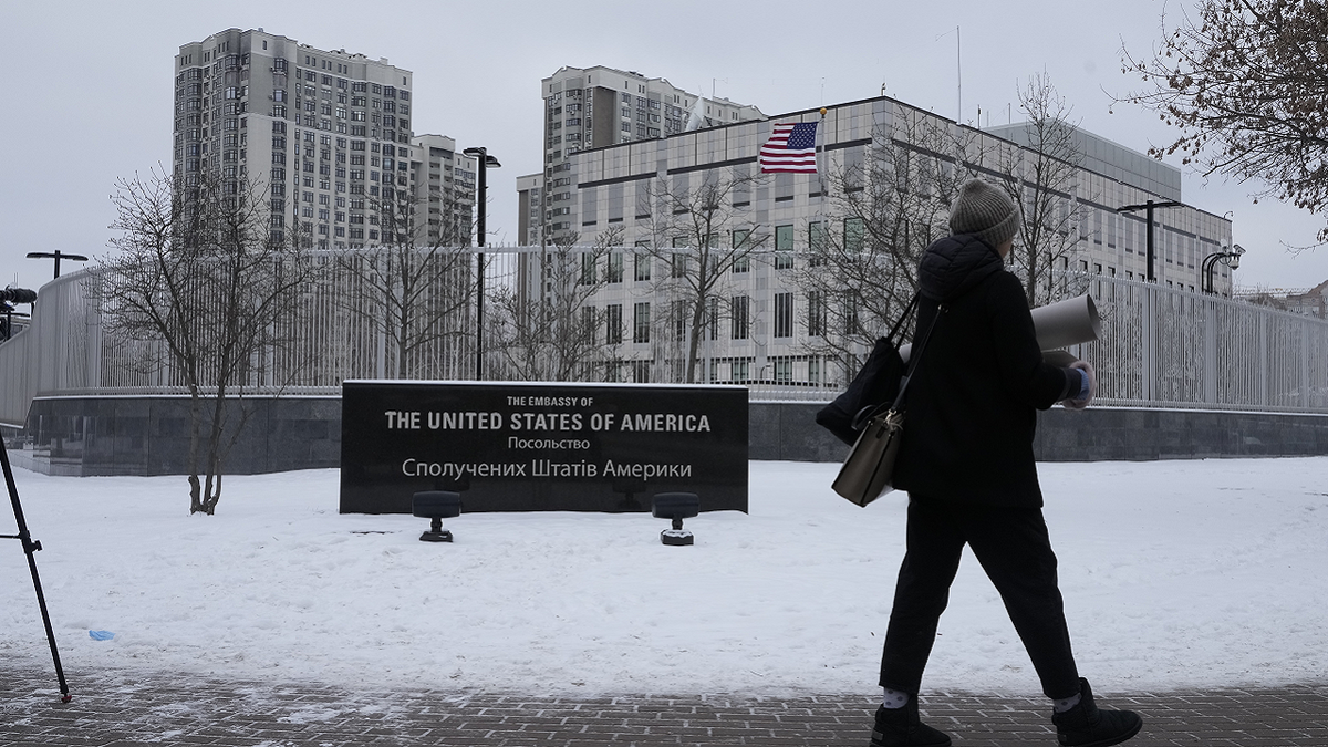 A woman walks past the U.S. Embassy in Kyiv, Ukraine, on Monday.
