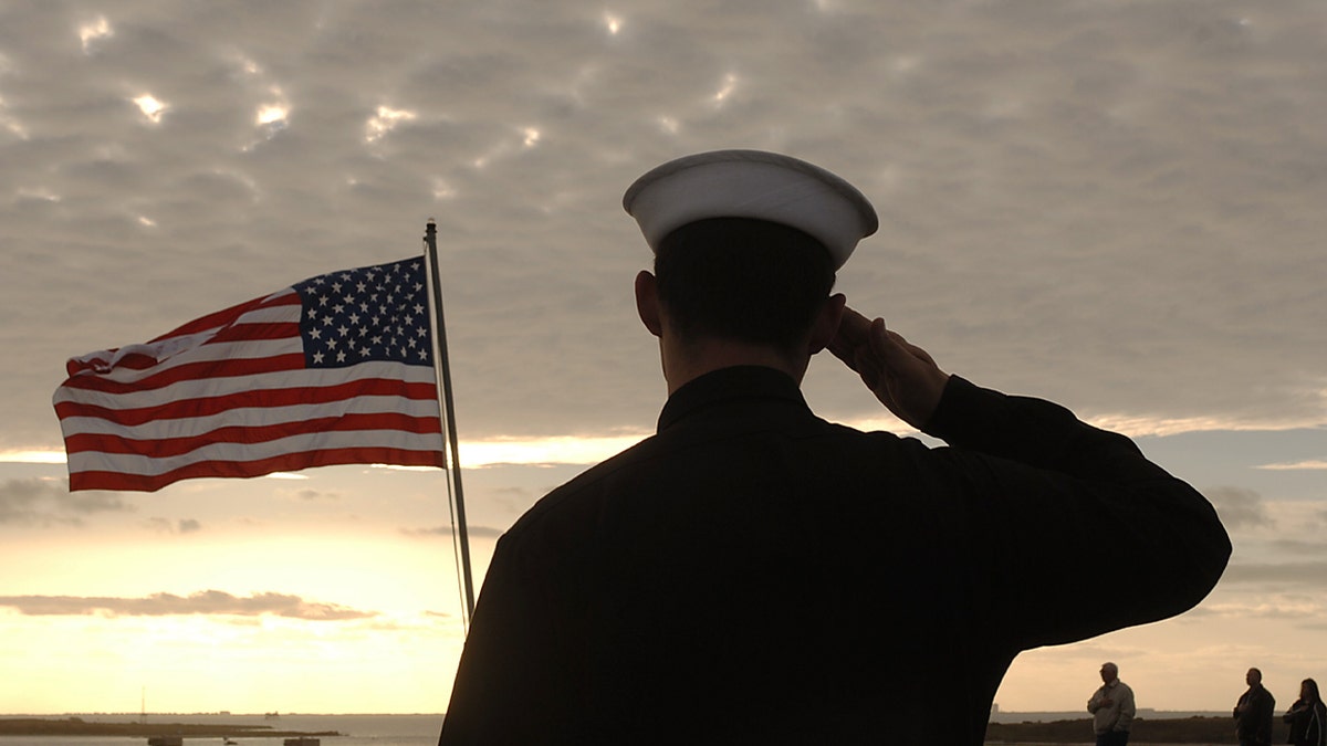 Sailors salute the American flag