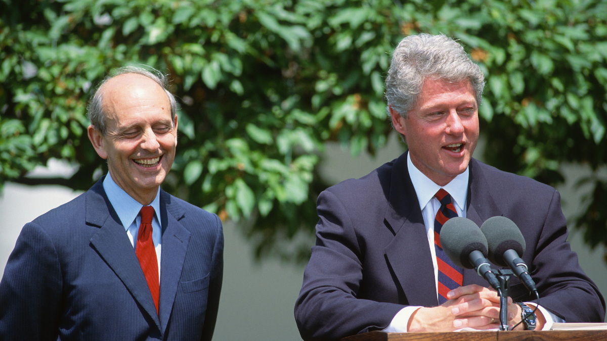 Chief Judge Stephen Breyer (left) listens as President Clinton