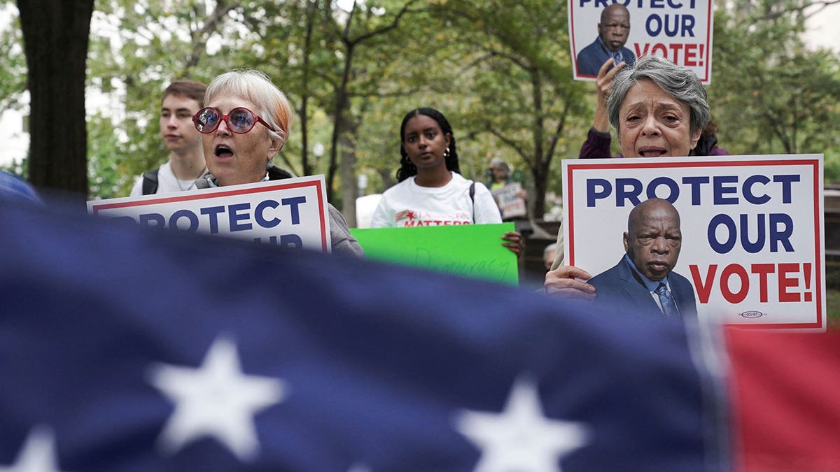 Voting rights activists rally at the Robert A. Taft Memorial and Carillon following a three-day, 70-mile "Freedom to Vote Relay" from West Virginia, in Washington, Oct. 23, 2021.