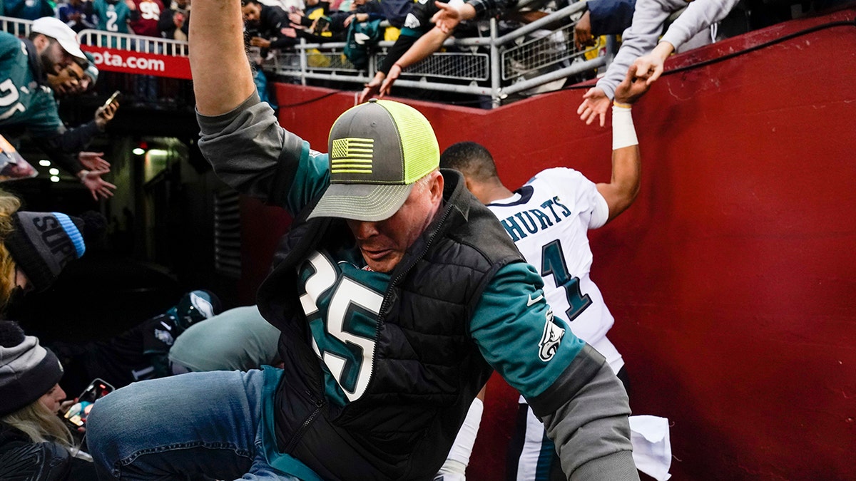 Fan falls near Jalen Hurts