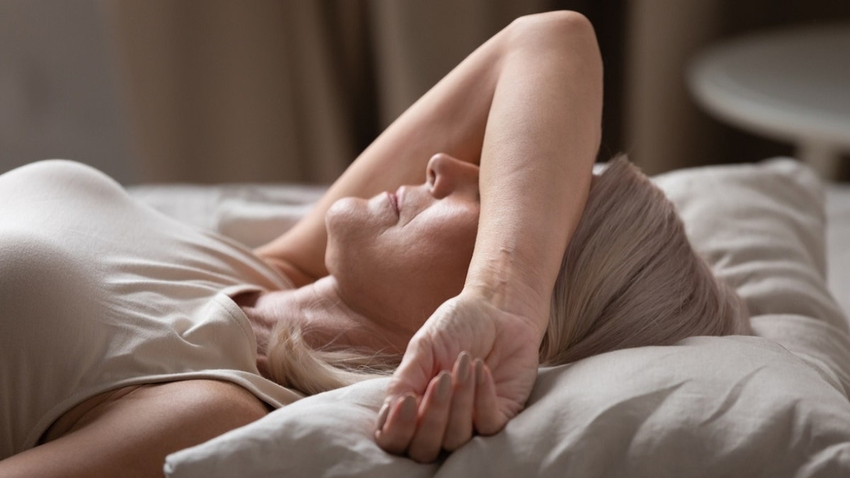 a woman trying to sleep with eyes covered