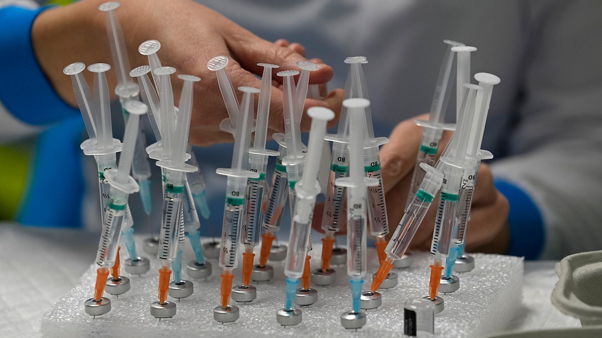 A nurse prepares vaccines in the Wizink Center, currently used for COVID-19 vaccinations, in Madrid, Dec. 1, 2021. 