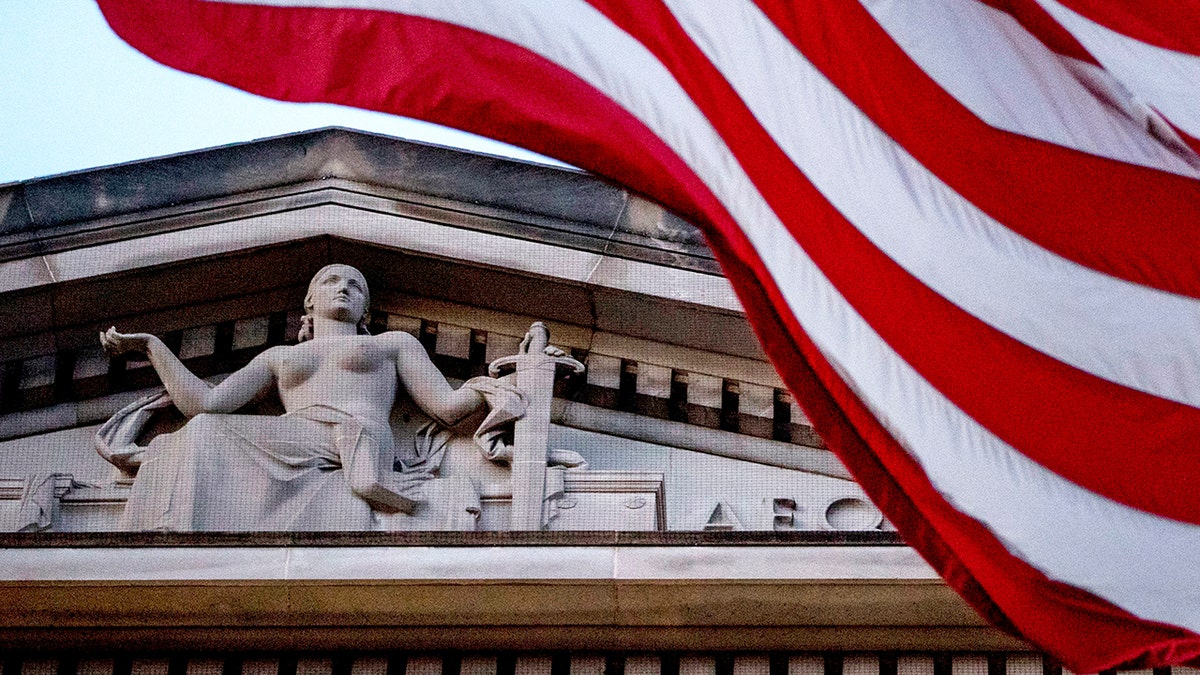 An American flag flies outside the Department of Justice in Washington, March 22, 2019. 