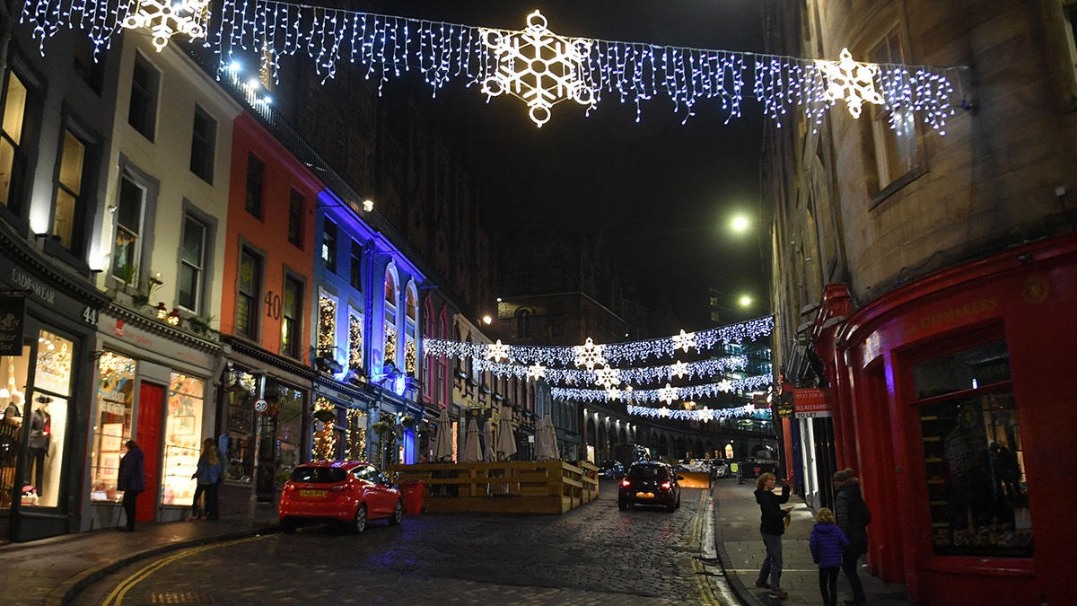A near-deserted Victoria Street in the center of Edinburgh on New Year's Eve, Dec. 31, 2021, as large-scale Hogmanay celebrations were canceled for the second year running in the city.