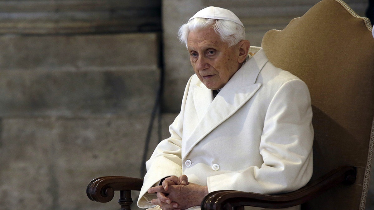 Pope Emeritus Benedict XVI sits in St. Peter's Basilica as he attends the ceremony marking the start of the Holy Year, at the Vatican, Dec. 8, 2015.