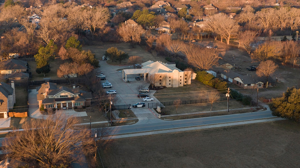 An aerial view of police standing in front of the Congregation Beth Israel synagogue, Sunday, Jan. 16, 2022, in Colleyville, Texas.