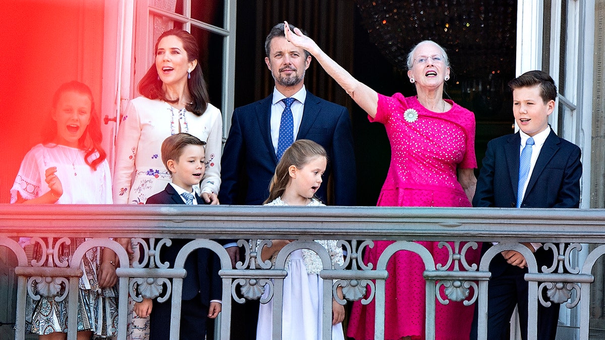 Queen Margrethe of Denmark, second right, and her son Crown Prince Frederik, center, stand on the balcony at Amalienborg Castle in Copenhagen on May 26, 2018, to celebrate the 50th birthday of the Crown Prince. 