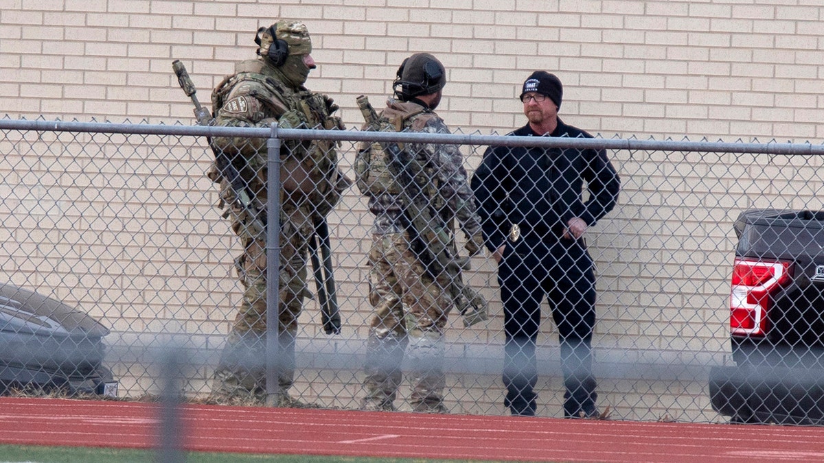 Law enforcement officials gather at a local school near the Congregation Beth Israel synagogue on Saturday, Jan. 15, 2022, in Colleyville, Texas.