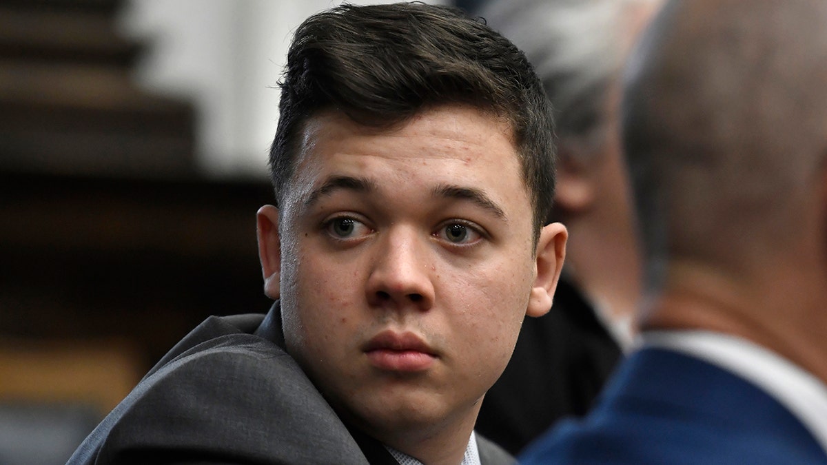 FILE- Kyle Rittenhouse looks back as attorneys discuss items in the motion for mistrial presented by his defense at the Kenosha County Courthouse in Kenosha, Wis., on Wednesday, Nov. 17, 2021.