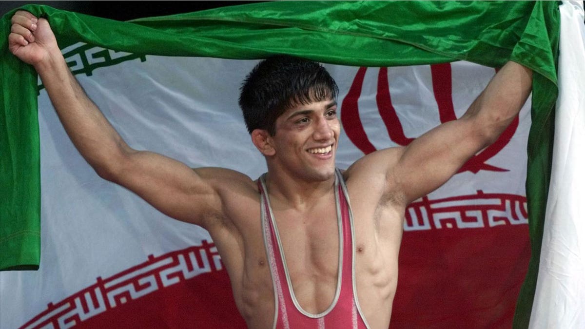 Alireza Dabir of Iran celebrates gold medal win for 58-kilogram Freestyle Wrestling at Sydney 2000 Summer Olympic Games, photo on black