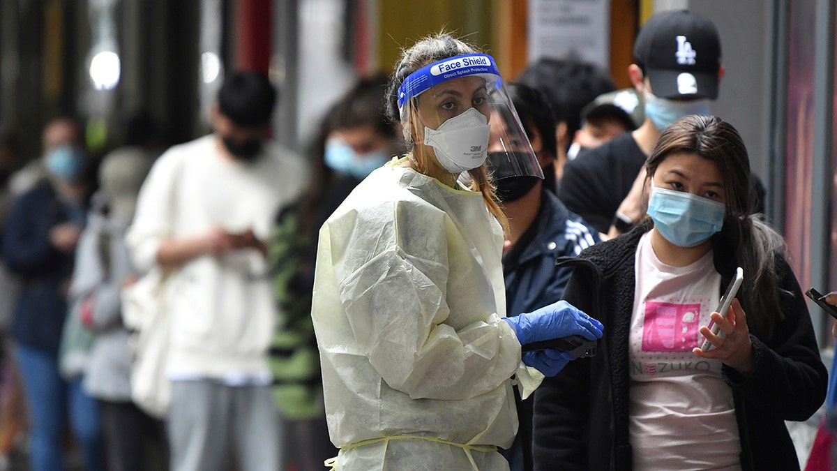 People queue at a walk-in COVID-19 testing site in Melbourne, Australia, Wednesday, Jan. 5, 2022.