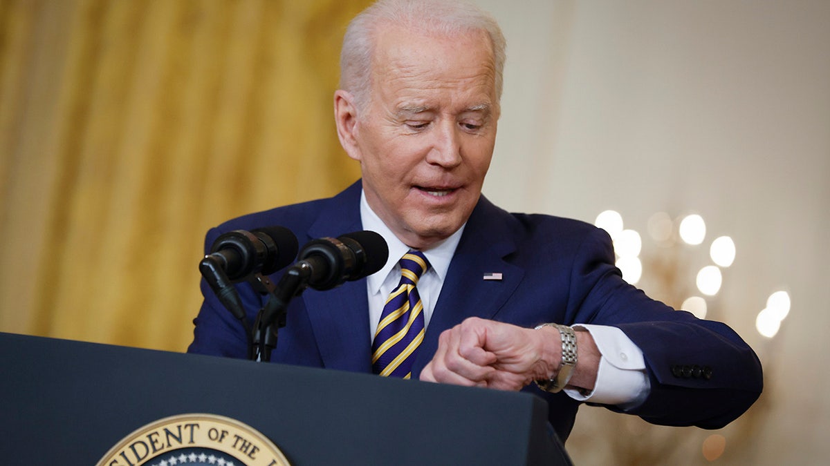 President Biden checks his watch