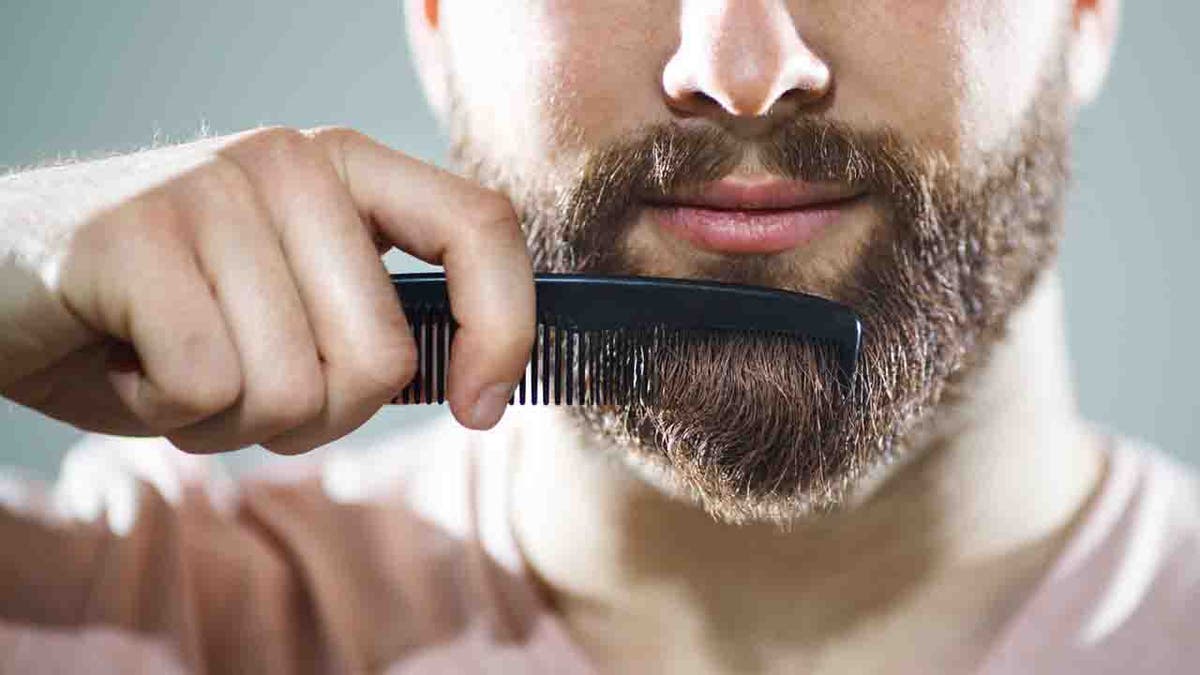 Man combing his beard