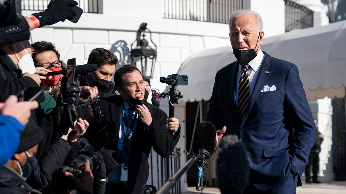 President Joe Biden talks to reporters