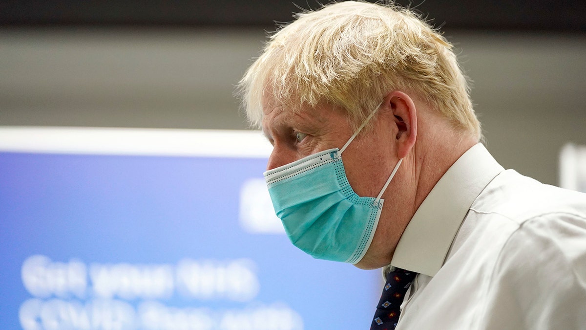 Britain's Prime Minister Boris Johnson visits a vaccination hub in the at Stoke Mandeville Stadium in Aylesbury, England, Monday Jan. 3, 2022, as the booster vaccination program continues.