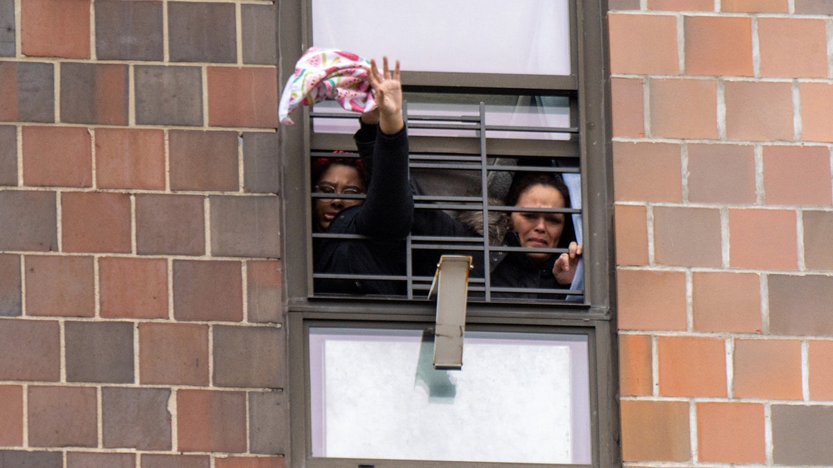 Residents trapped inside the apartment building pleading for help. 