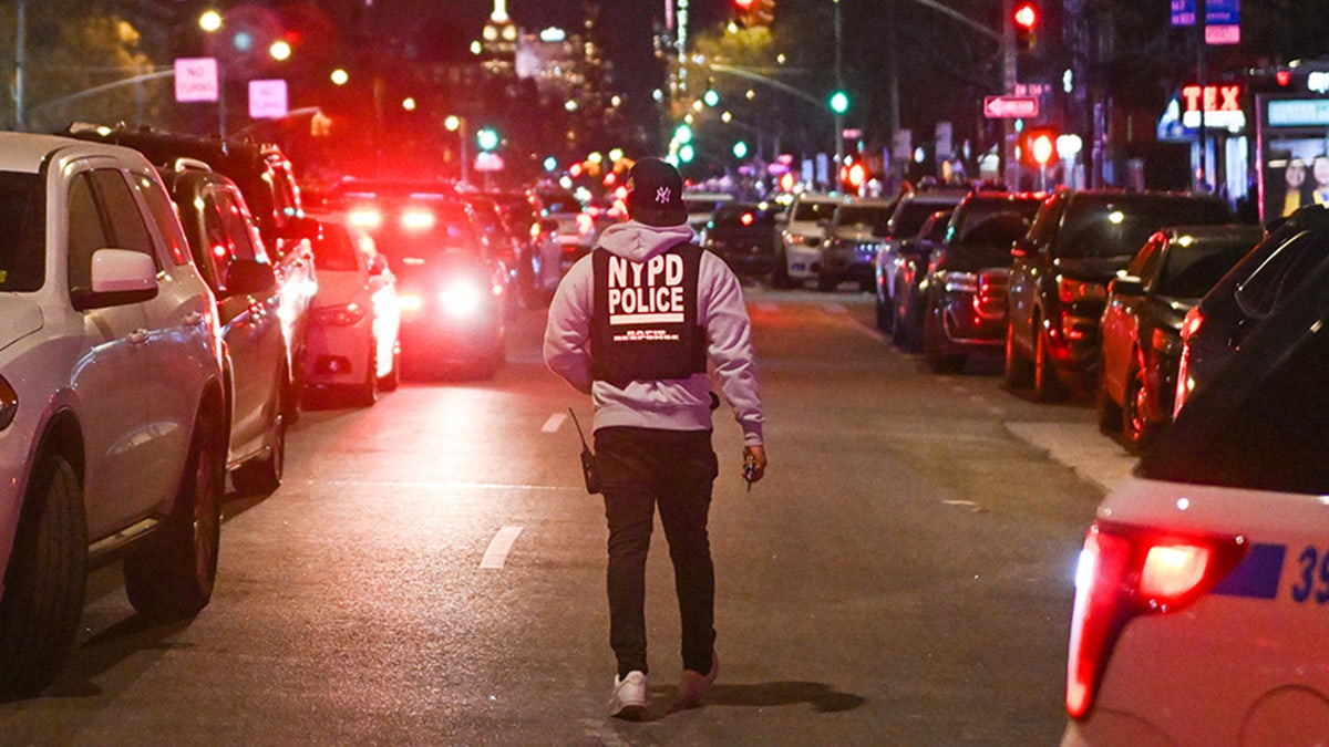 Police officers lock down the scene after two NYPD officers were shot in Harlem on Jan. 21, 2022, in New York City. 