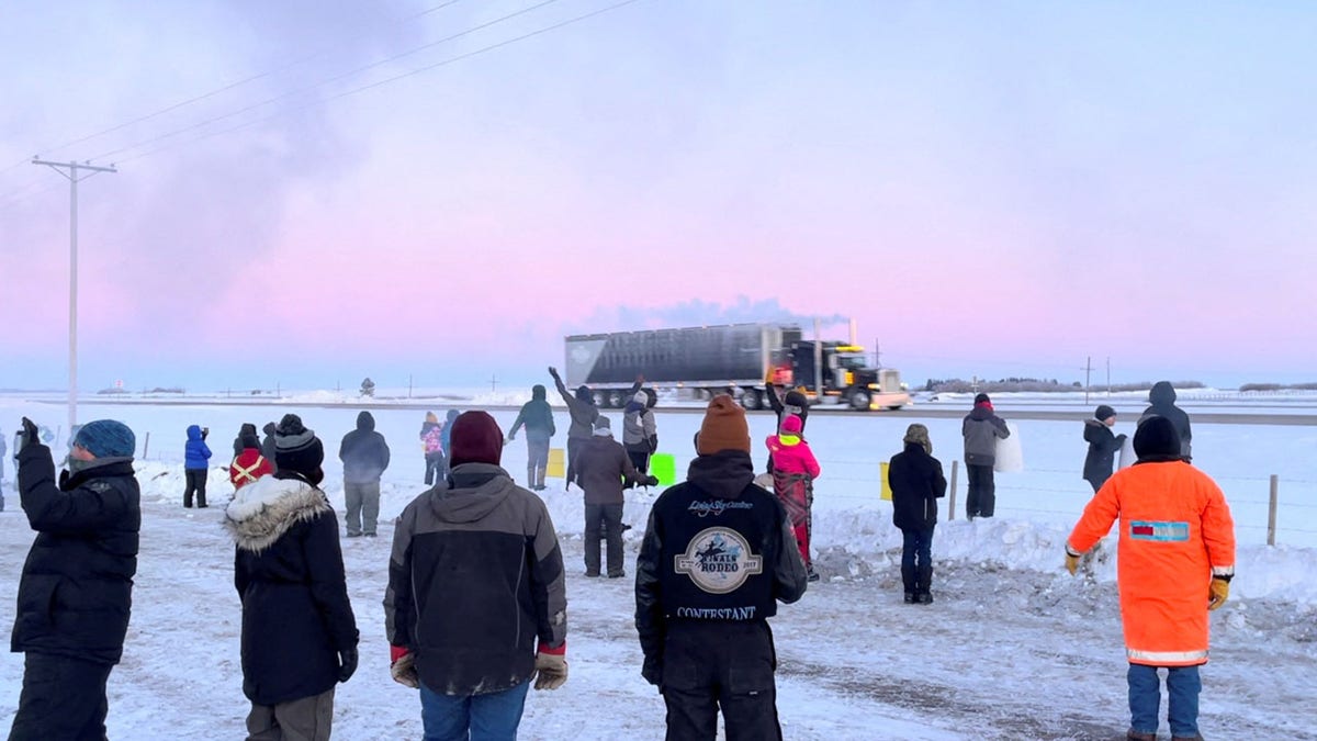 Family, friends and neighbours gather to show support for the freedom convoy on the Trans-Canada highway in Grenfell, Saskatchewan, Canada January 25, 2022 in this screenshot obtained from a video on social media. Mark Dimler/via REUTERS THIS IMAGE HAS BEEN SUPPLIED BY A THIRD PARTY. MANDATORY CREDIT. NO RESALES. NO ARCHIVES.
