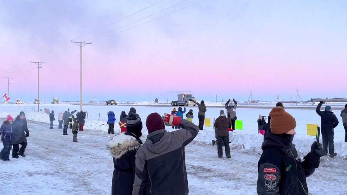 Family, friends and neighbors gather to show support for the freedom convoy on the Trans-Canada highway in Grenfell, Saskatchewan, Canada Jan. 25, 2022, in this screenshot obtained from a video on social media. 