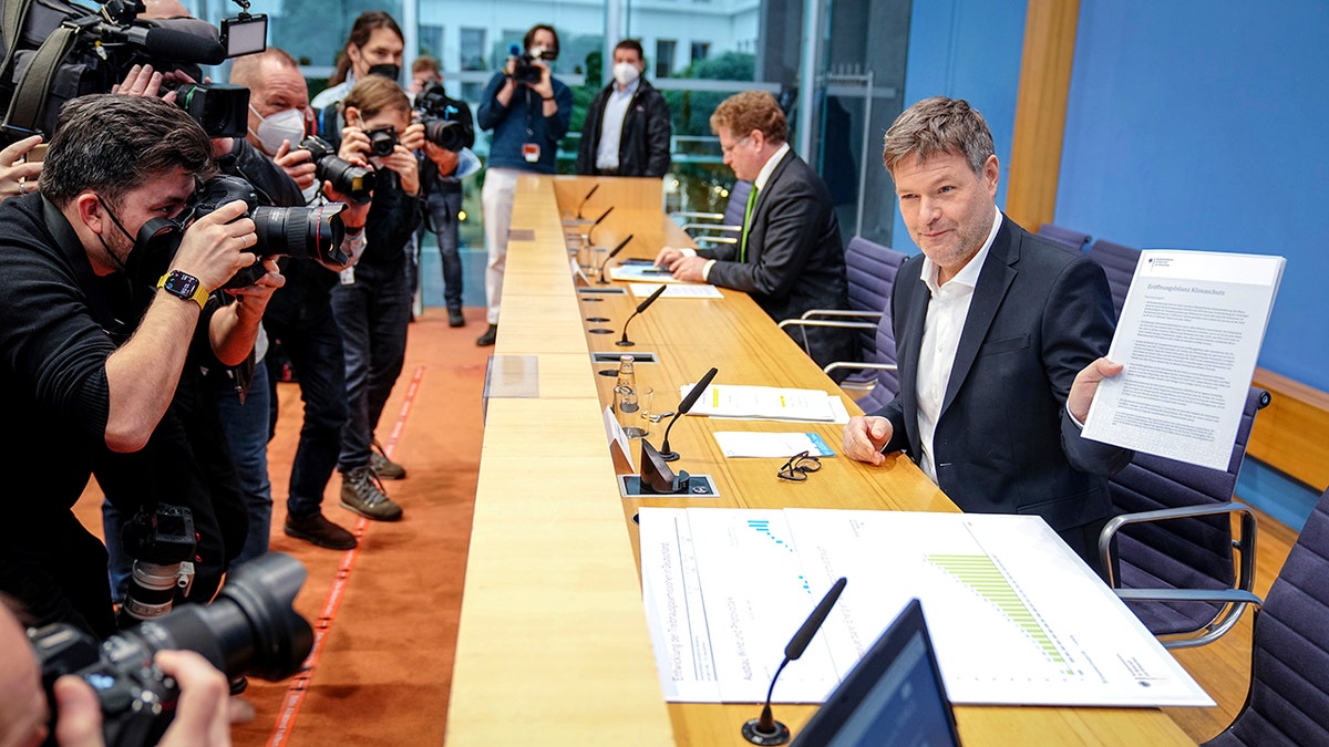 German Economy and Climate Minister Robert Habeck shows a report named 