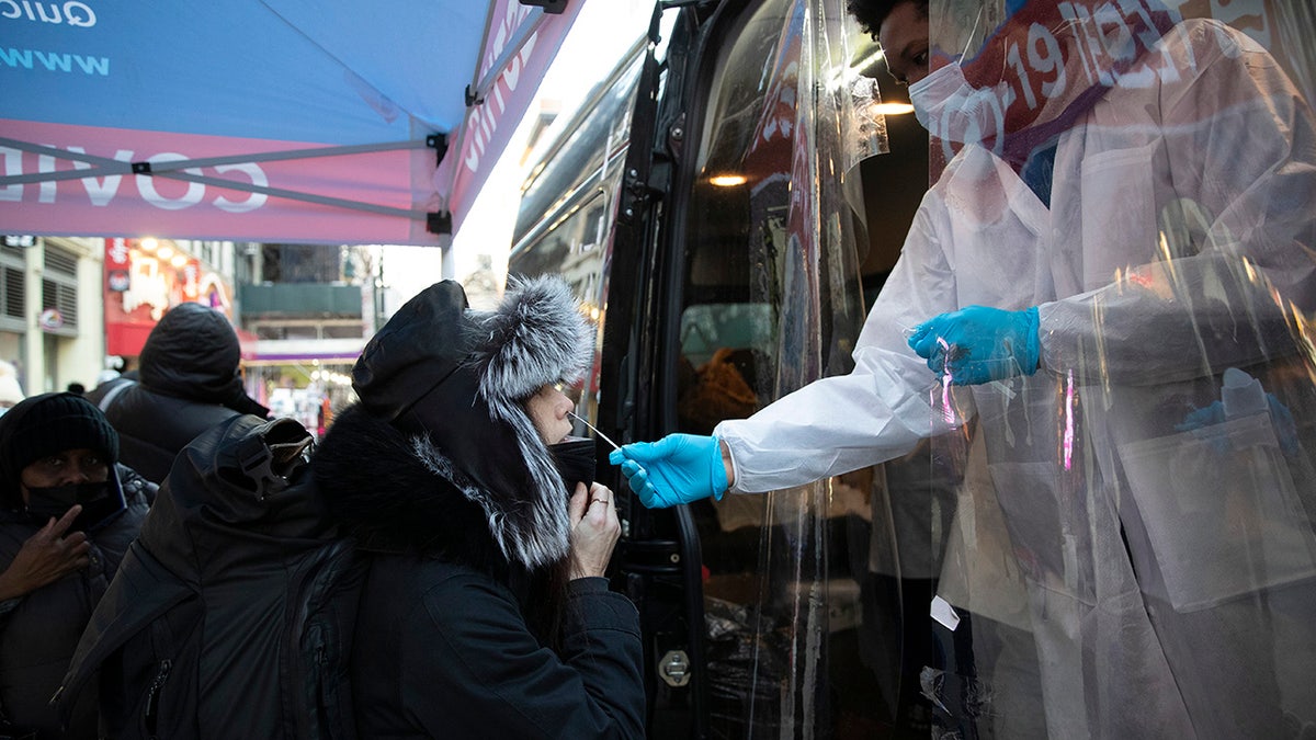 A woman gets tested at a mobile COVID-19 testing van on 14th Street in Manhattan on Jan. 4, 2022, in New York City. 