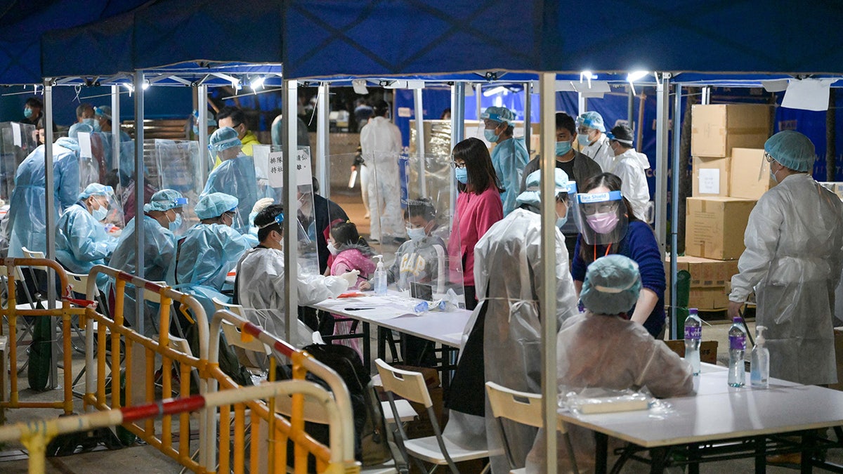 Residents register after receiving COVID-19 test at Tsui Ning Garden on Jan. 4, 2022, in Hong Kong.