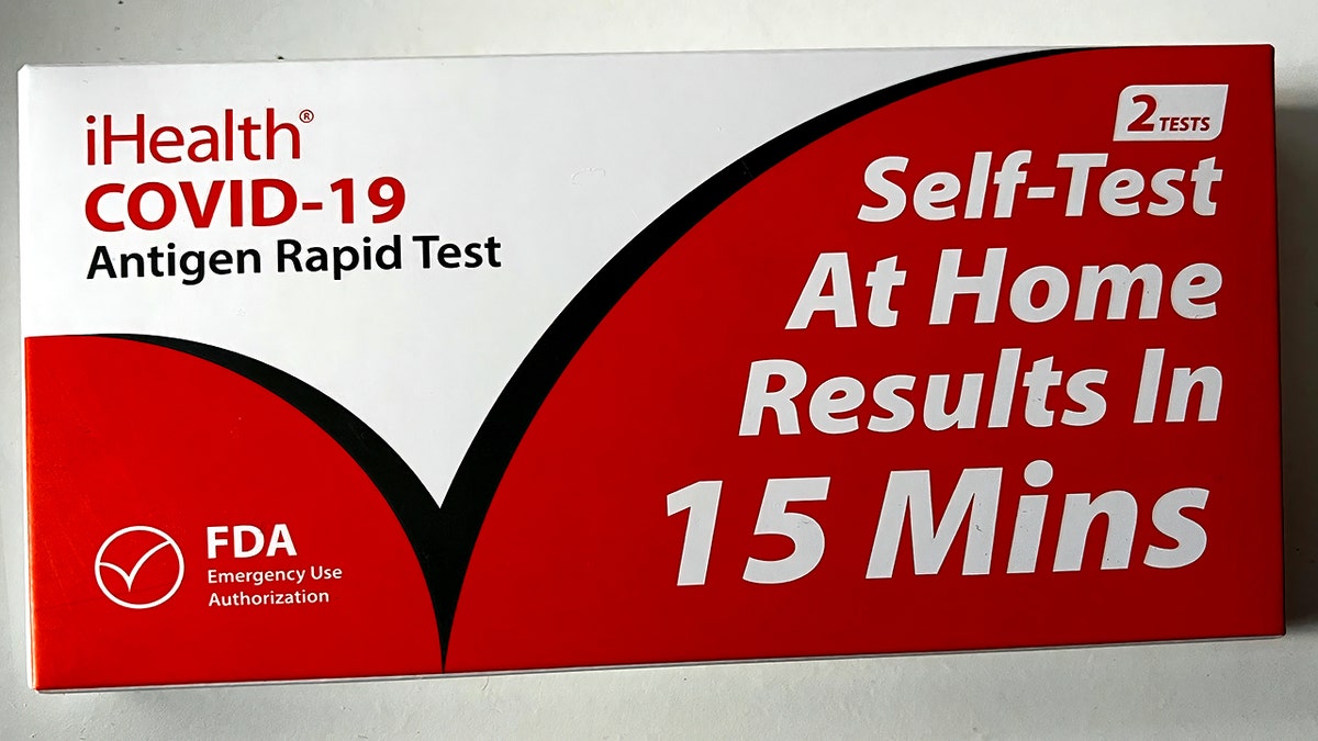 At home COVID test with "results in 15 min" sign on front 