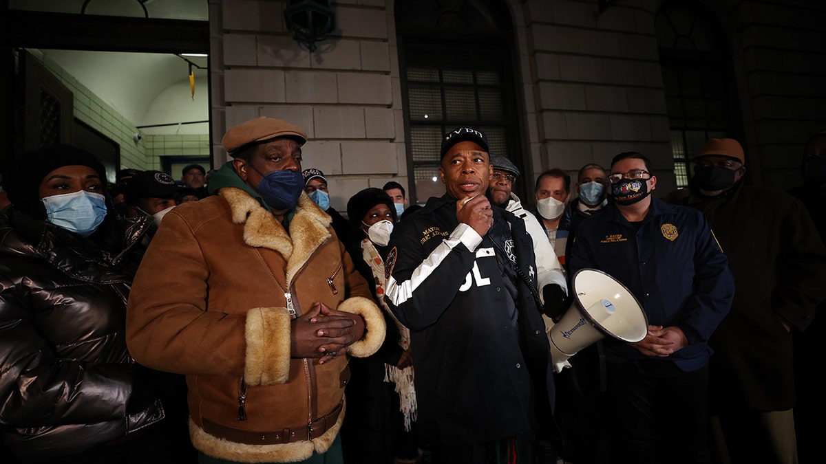 New York City Mayor Eric Adams speaks as hundreds of police officers and firefighters gather at the 32nd Precinct in Harlem for vigil honoring two officers who were shot Friday night.